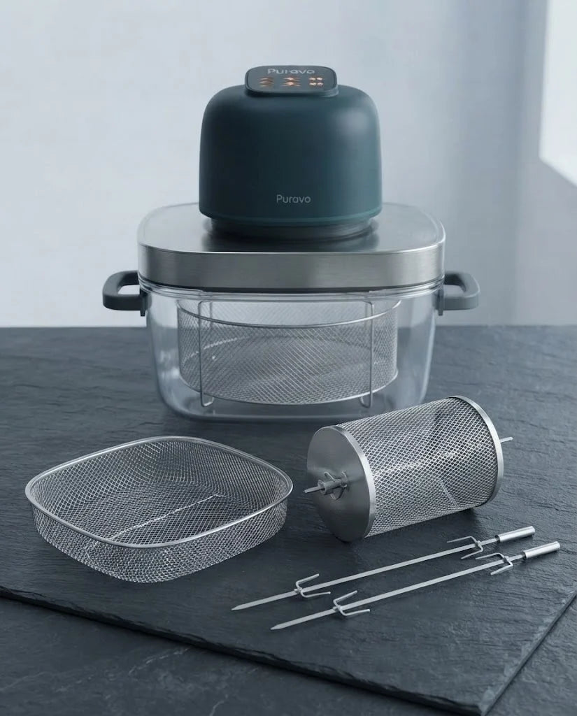 The stainless mesh basket, rotisserie basket and skewers of Puravo Glass laid out on a slate counter