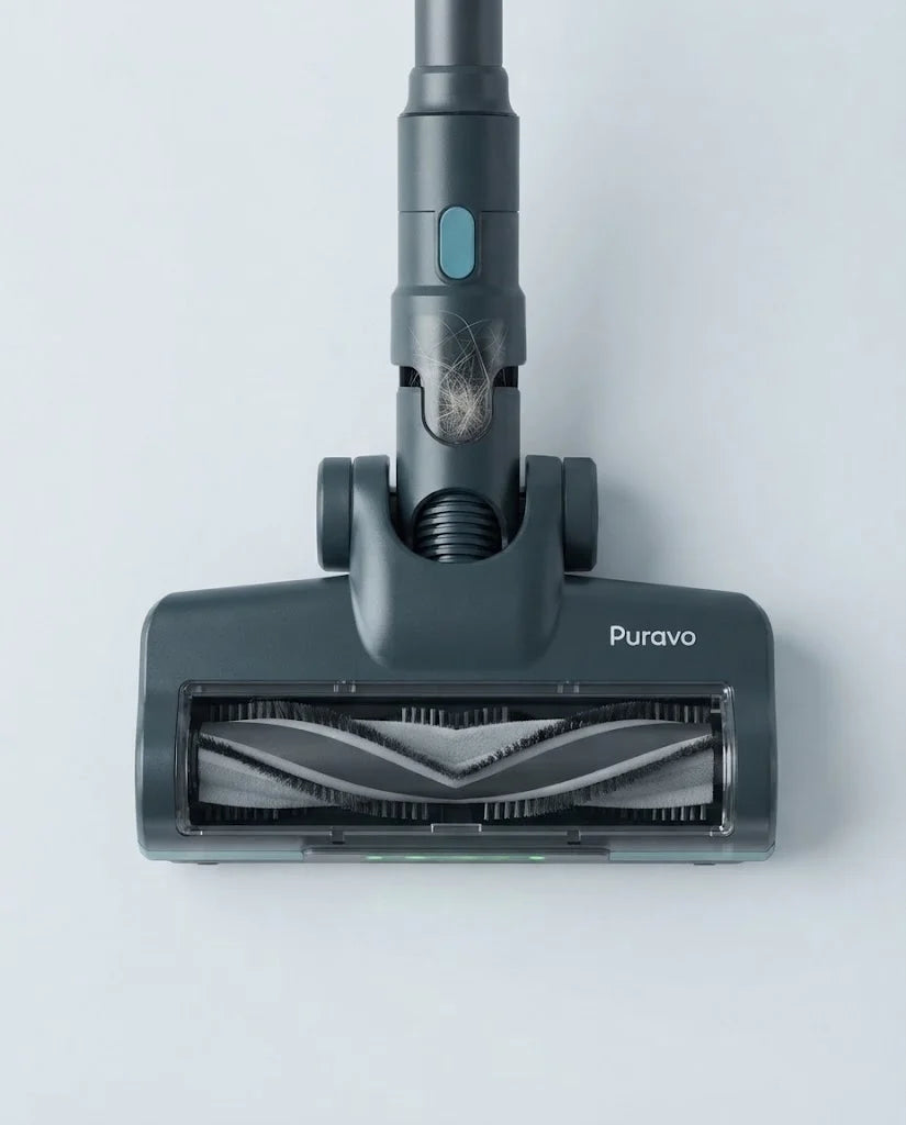 Close-up of the Puravo Stick V-shaped anti-tangle roller, clean, with hair in the dust cup above