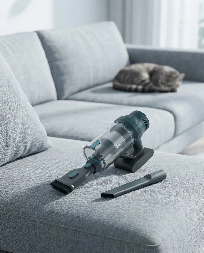Puravo Stick in its handheld form with the upholstery tool on a grey sofa